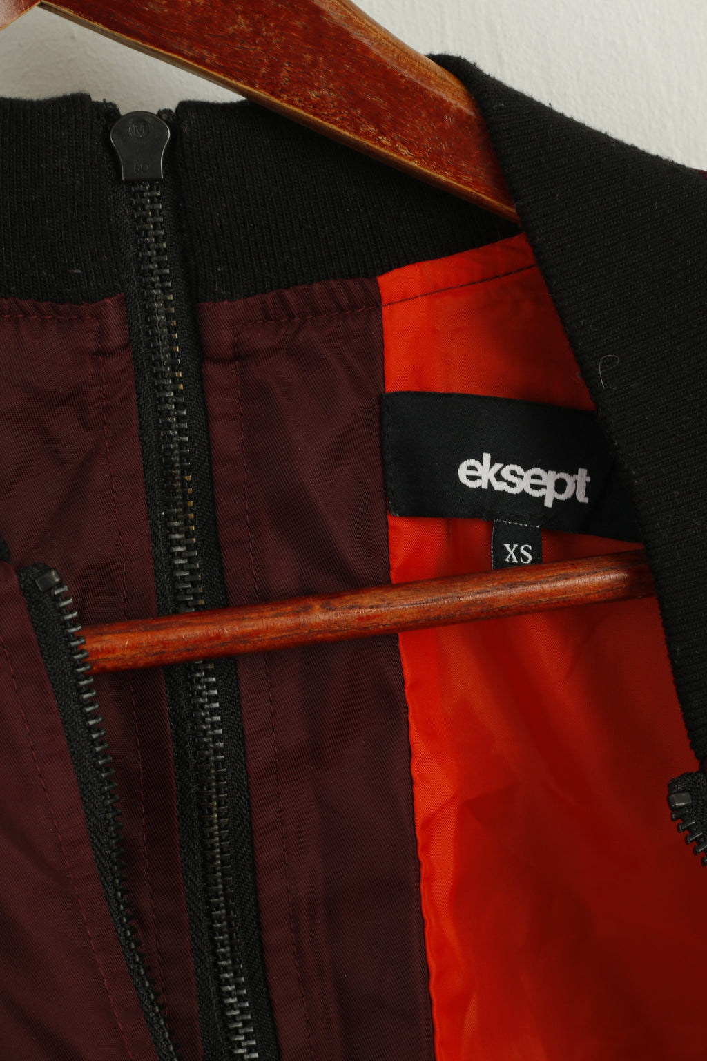 Close-up of a red and black bag with a visible brand label.