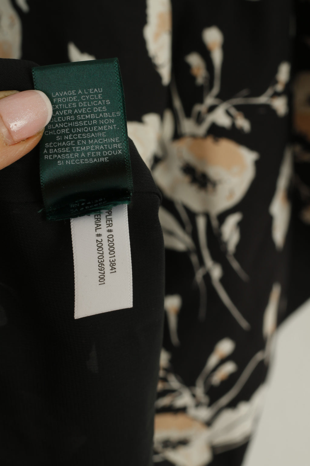 Close-up of a label on a garment with text and numbers.