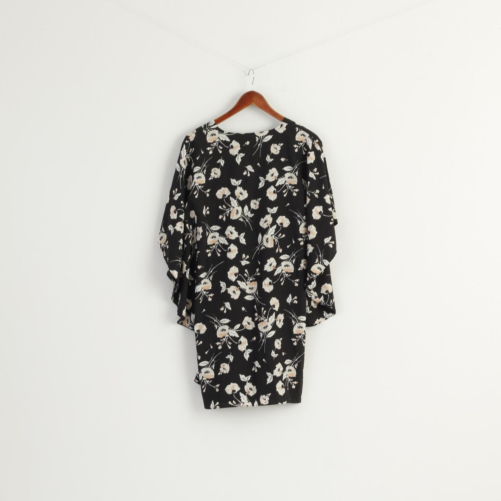 Black dress with floral pattern on a hanger against a white background