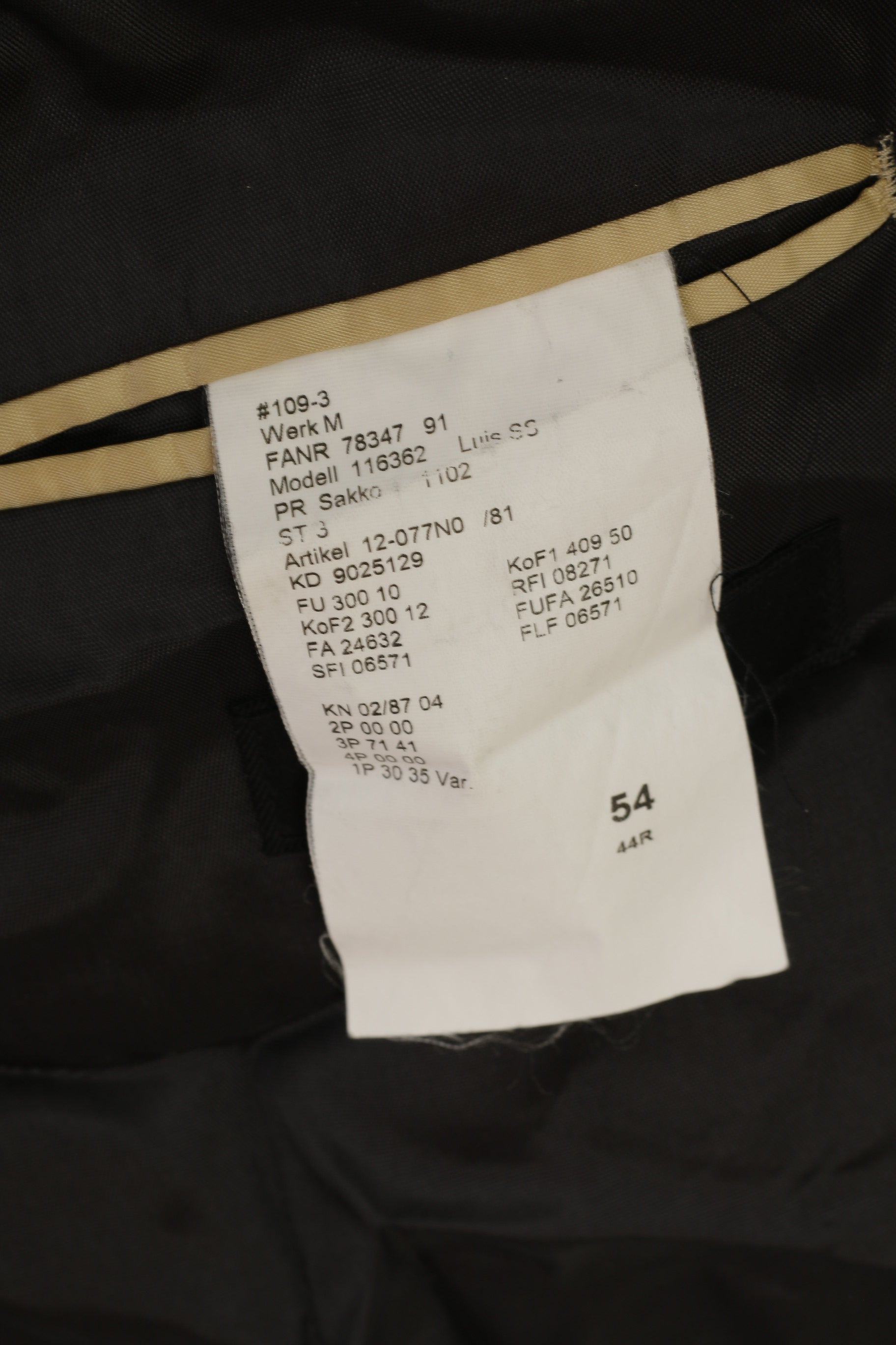 Clothing tag with text and numbers on a dark fabric background